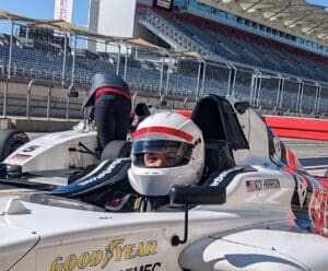 Image of a person in a formula 4 car
