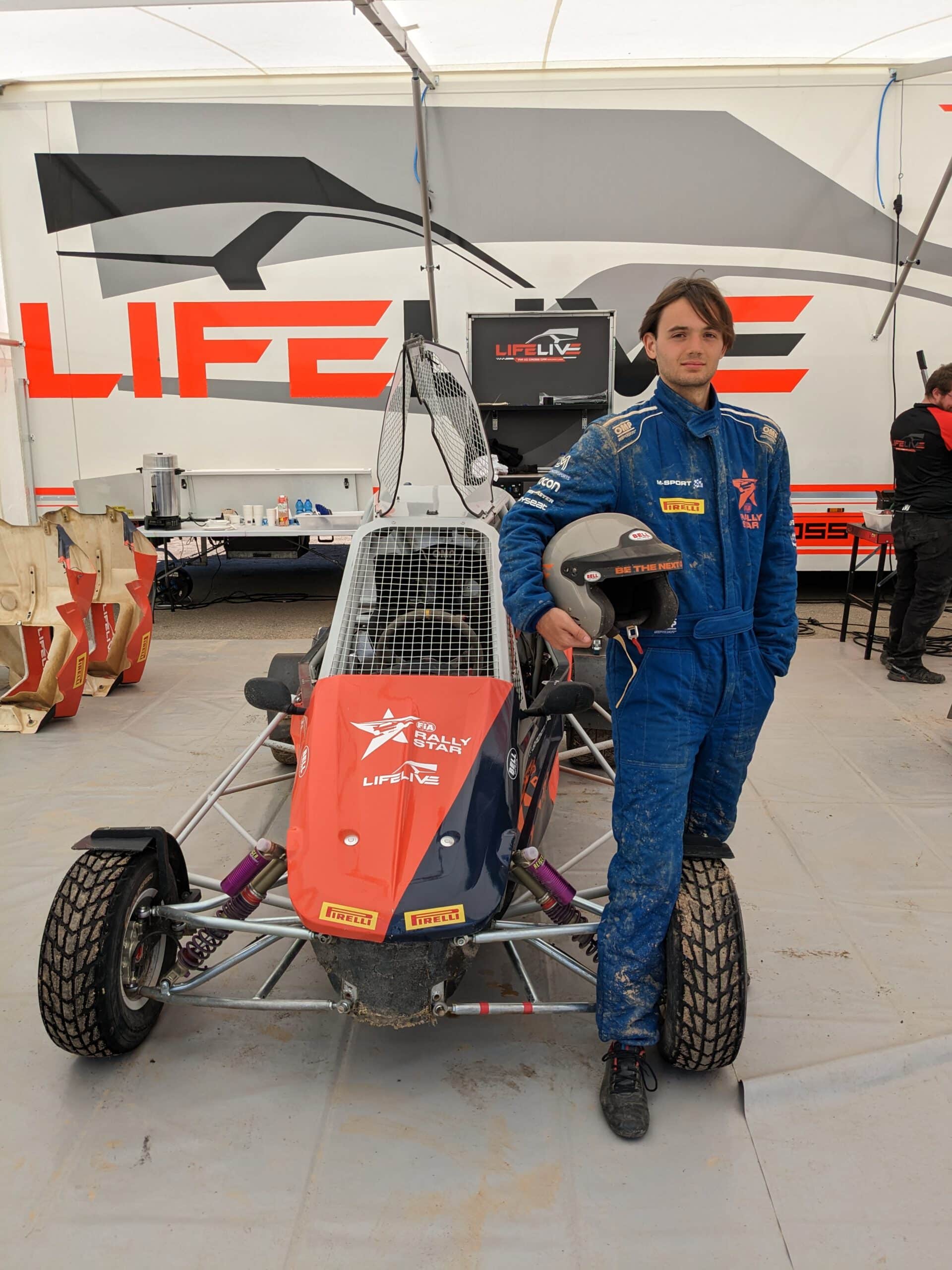 Standing next to the FIA Rally Star Cross Kart